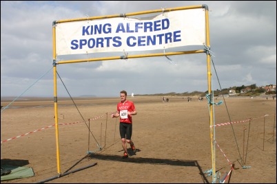 Chris Stuart of the Army Triathlon teams crosses the finishing line on Sunday April 9th