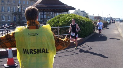 Runners pass a marshal during the 2006 Burnham Aquathon
