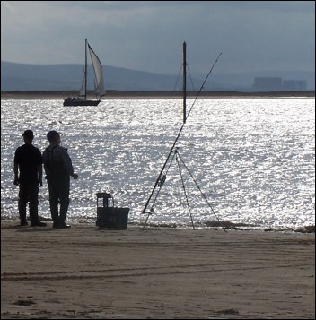 Fishermen on Burnham-On-Sea Beach with Hinkley Point in the background
