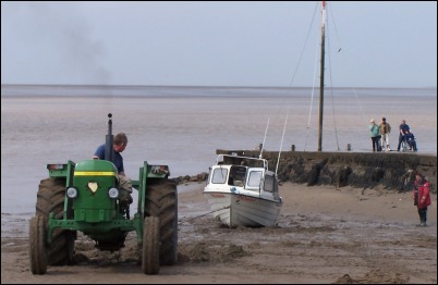 A tractor was brought in to try and move the wedged boat