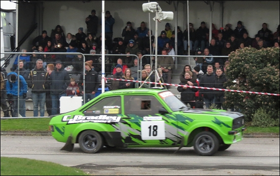 Brian Davis and Ian Davis powering past the stands in their Ford Escort 