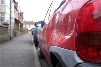 A dented car in the street