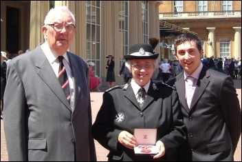 Pat with her husband and grandson outside Buckingham Palace