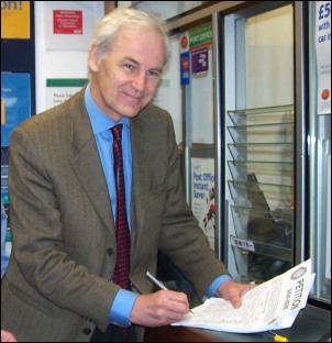 Watched by Burnham post office staff, the MP signed the petition