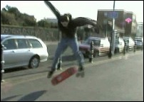 A skateboarder uses the seafront