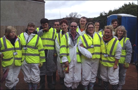 Staff from Burnham s Tesco store help floods clean up in Moorland