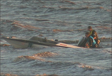 The crew struggle to keep the boat afloat in the heavy waves