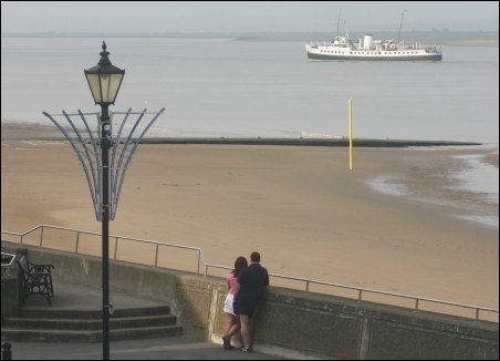 A couple watched as the Balmoral ship passed Burnham's jetty on Friday