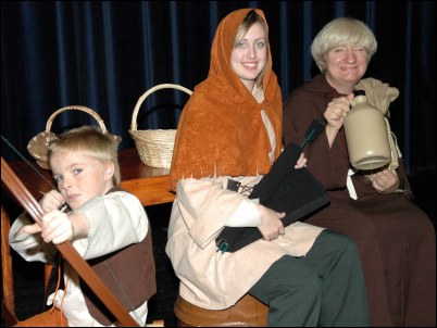 Stacey as Robin Hood and Sandra Hart as Friar Tuck, with David practising his bow and arrow skills.