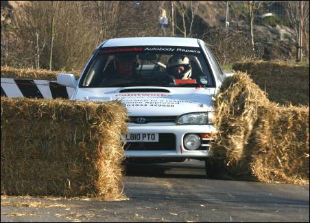 John Wood and Marie Wood ploughing through hay bales in the chicane [Photo: Al Crook]