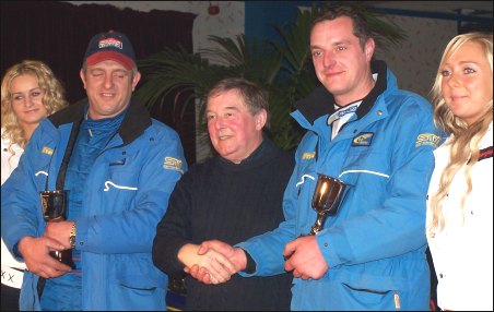 Jamie Vincent and Richard Walters receive their award from Russell Brookes