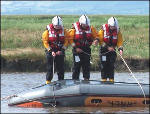 After attaching ropes to the sides of the boat, the crew jointly fall backwards into the water