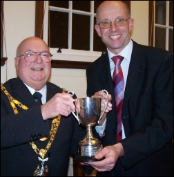 Tim Potts, properietor of Sentiments in the High Street, collects his prize from Mayor Eric Gill