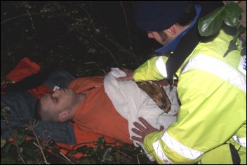 A coastguard member assists one of the casualties
