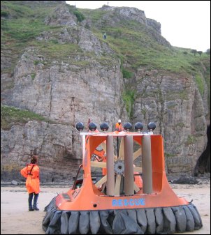 Using radio receivers, the hovercraft crew guide the Coastguard cliff rescue team to the 'casualty'