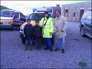 The three safely back on shore with Coastguard Officer Steve Bird [Mobile phone photo]