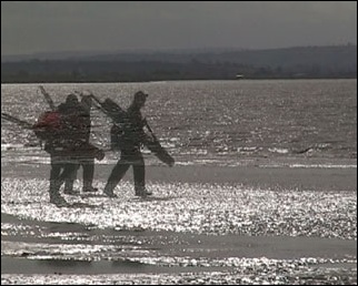 Fishermen walking at Burnham-On-Sea on the video