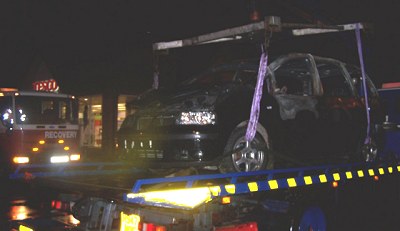 The burnt-out wreck of a car was also towed away