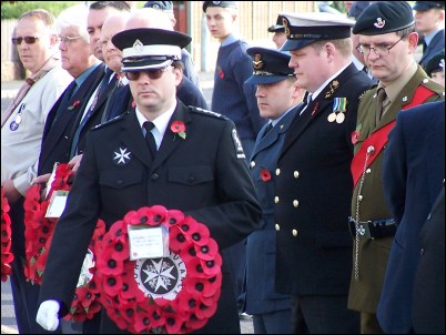 St John Ambulance Divisional Superintendent Keith Gough lays a wreath during the ceremony
