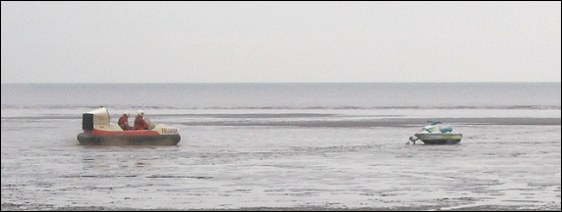 The trial hovercraft speeding heading in the direction of the stranded jet ski