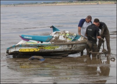 The jet ski had sunk into the mud on a trailer