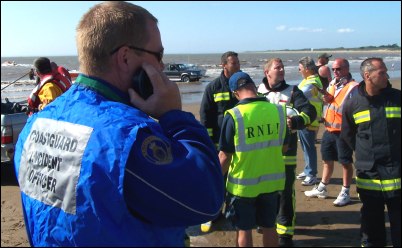 Coastguard officer Steve Bird at Sunday's incident with RNLI and fire crews in the background