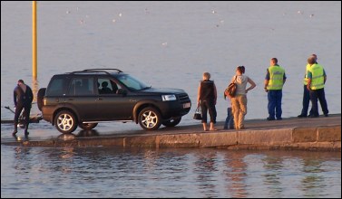 Members of Burnham Coastgyard watch from the town's jetty