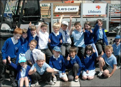 Children from St Jospeh's School besides one of the Burnham lifeboat station launching tractors and carts