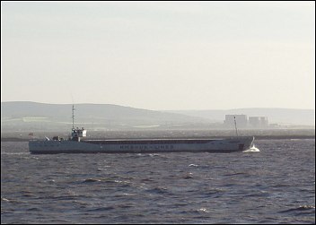 A cargo ship glides into Bridgwater Bay past Burnham-On-Sea