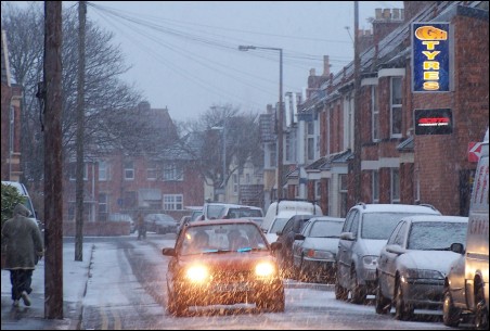 Cars are covered in snow in Adam Street, Burnham-On-Sea