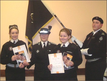 New cadets Claire Sealey and Siobhan Russ being enrolled by Assisstant Commissioner Youth Sue Winter. Cadet Tom Hancocks is holding the flag