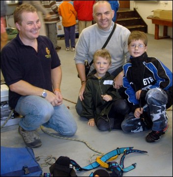Coastguard Station Officer Steve Bird shows a family some cliff rescue gear