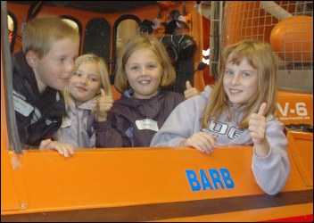 Children step onboard Burnham's Spirit Of Lelaina hovercraft. Ruth, Caleb, Hayden, Katie and Bonnie try out the cockpit of the hovercraft.