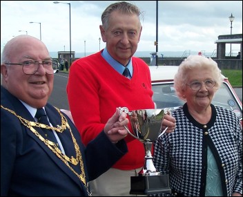 Burnham Mayor Eric Gill presents a trophy to winners Eric and Marjorie Upshall