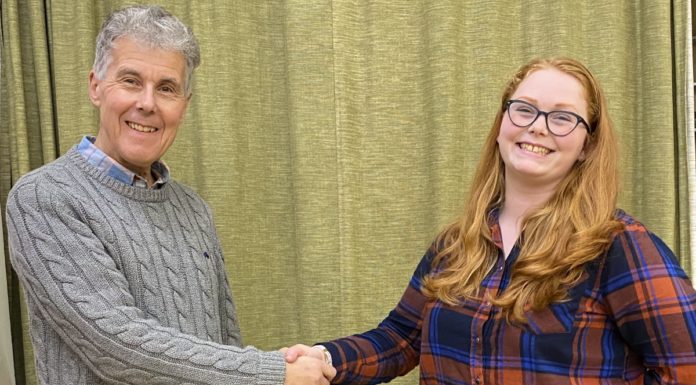 Burnham and Highbridge Town Band Principal Cornet Bill Sutton greets new conductor Felicity Day