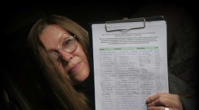 Joy Russell with the petition over Highbridge Lakeside homes plan
