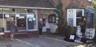 Burnham busker Taylor Topham entertains customers at Brent Knoll shop