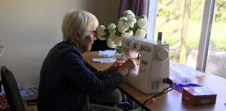 Pat Casey sewing scrubs at home