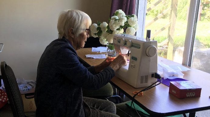 Pat Casey sewing scrubs at home