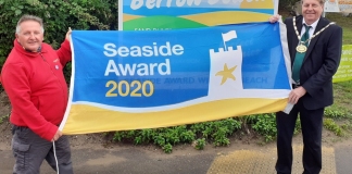 Chairman of Sedgemoor District Council, Cllr Peter Clayton, raising the Blue Flag with Berrow’s beach warden