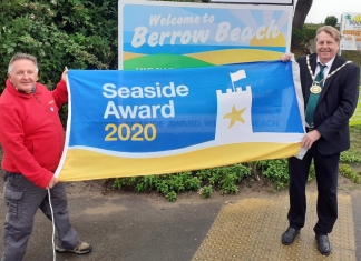 Chairman of Sedgemoor District Council, Cllr Peter Clayton, raising the Blue Flag with Berrow’s beach warden