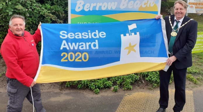 Chairman of Sedgemoor District Council, Cllr Peter Clayton, raising the Blue Flag with Berrow’s beach warden