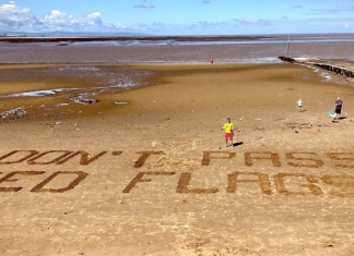 RNLI lifeguards use sand signage to keep beachgoers safe at Burnham-On-Sea