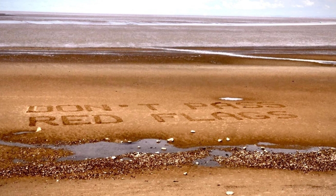 RNLI lifeguards use sand signage to keep beachgoers safe at Burnham-On-Sea