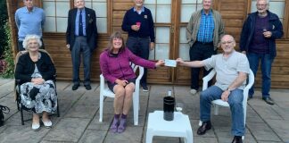 Burnham-On-Sea Rotary President Terry handing over a cheque donation of £100 to Karen Penny.