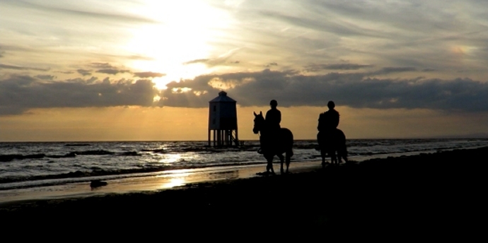 Horse riders next to Burnham-On-Sea lighthouse