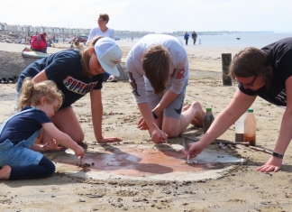 Beach mud painting session on Brean beach near Burnham-On-Sea