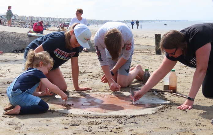 Beach mud painting session on Brean beach near Burnham-On-Sea