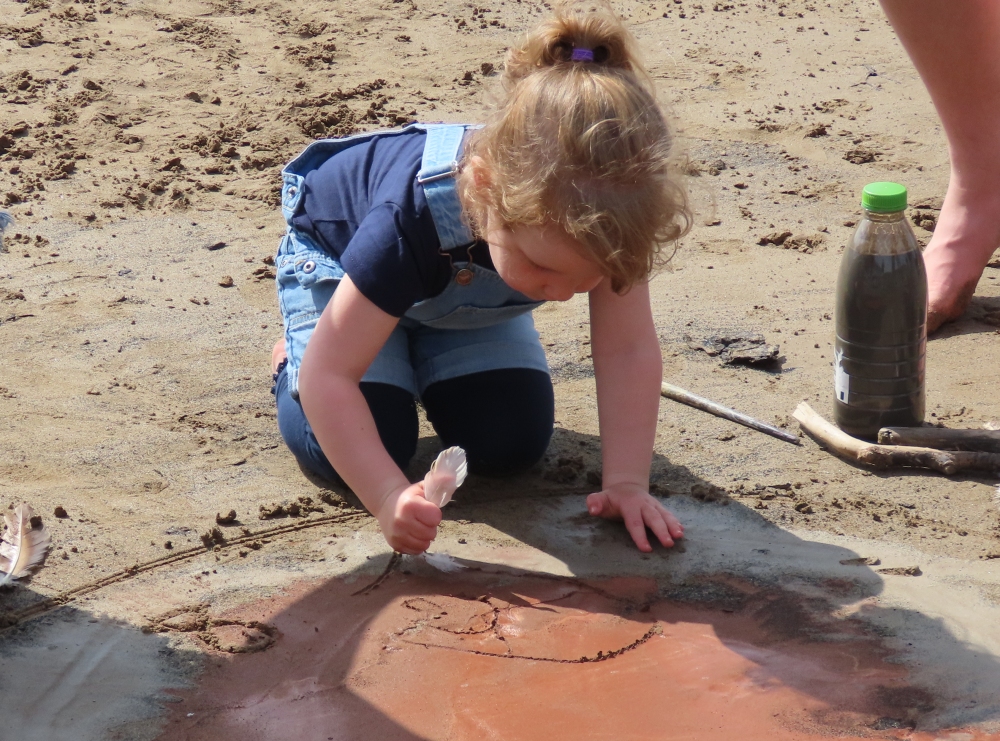 Beach mud painting session on Brean beach near Burnham-On-Sea