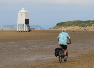 Cyclist cycling along Burnham-On-Sea beach